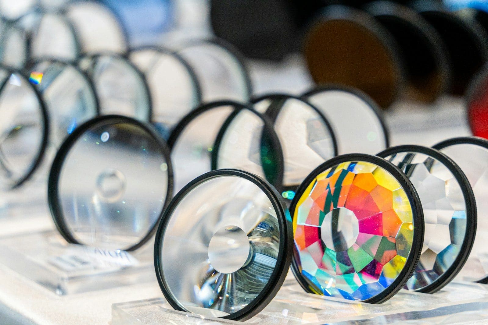 Different types of magnifying glasses including handheld, lighted, and loupe styles arranged on a table